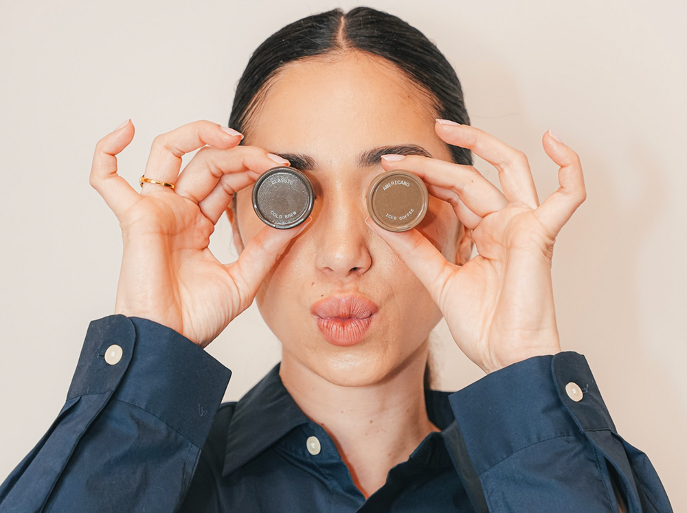 Person holding MadCoffee over eyes